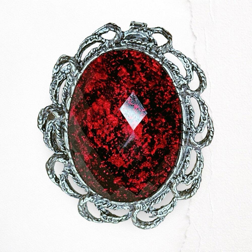 642. Red Plastic Pewtertone Brooch